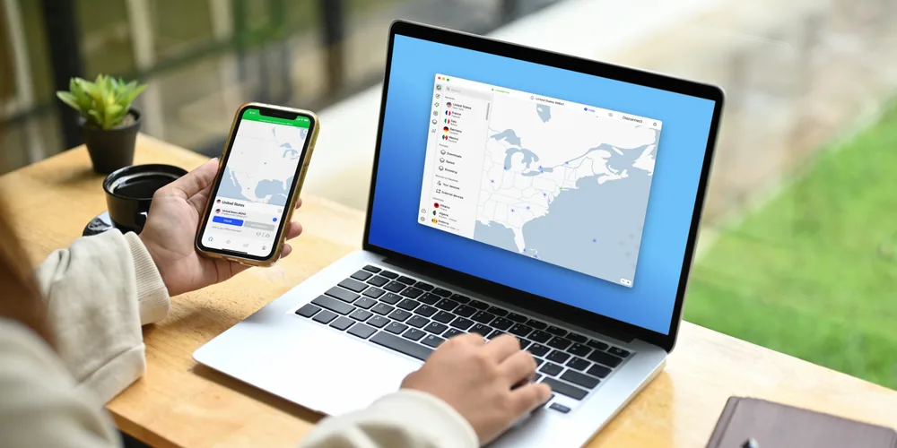 A traveller using the NordVPN app on a phone and a laptop at the same time