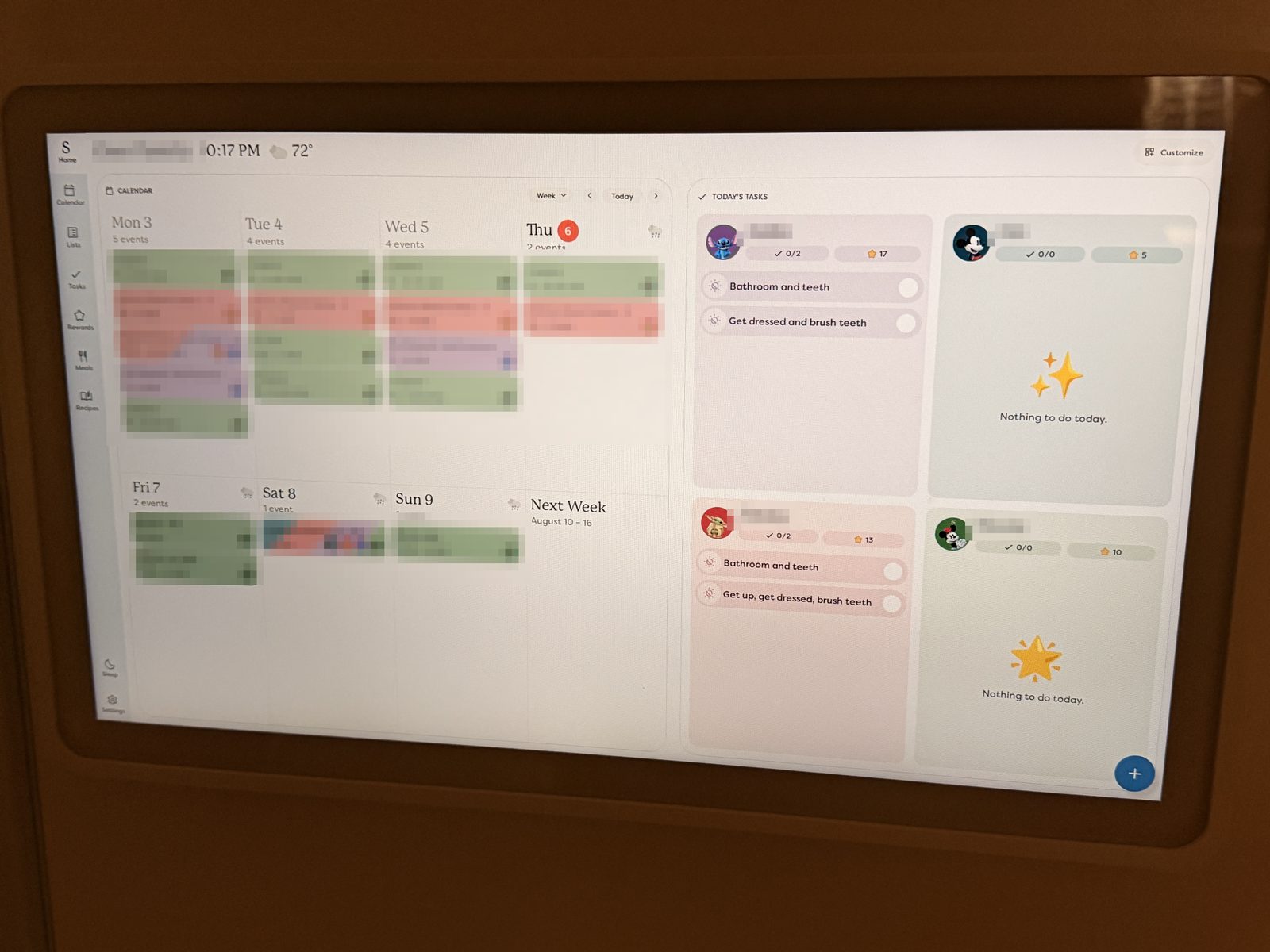 Skylight Calendar 15-inch mounted on a wall showing a family's color-coded week view with a tasks panel